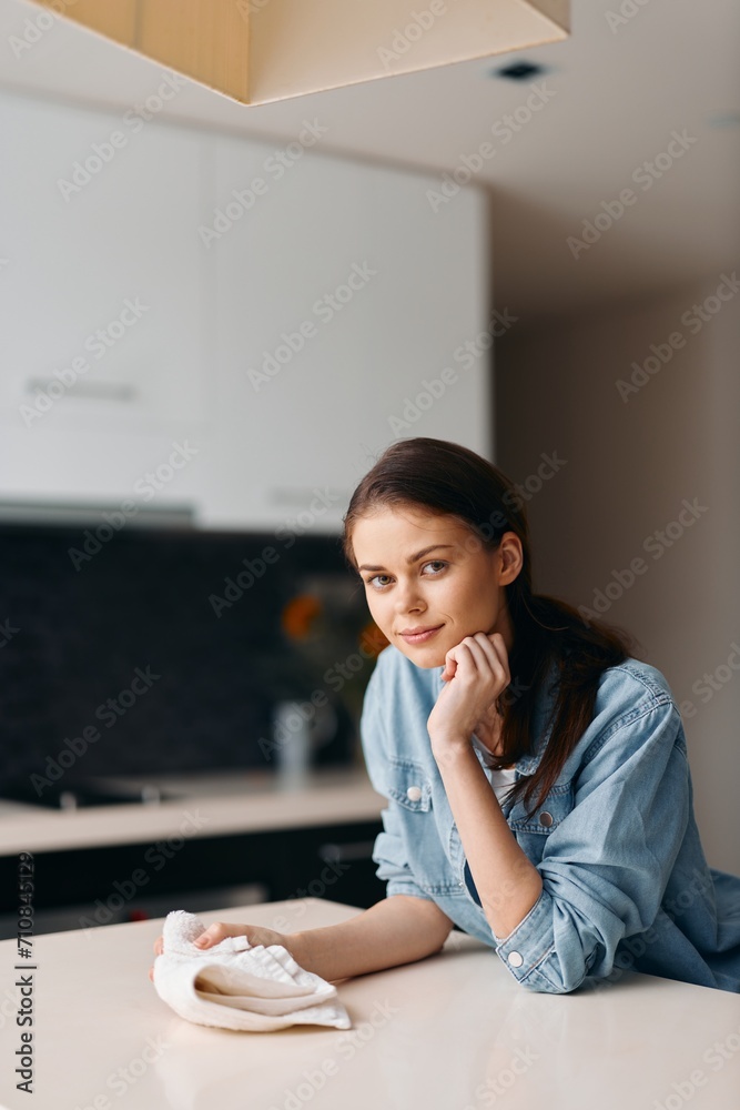 Thoughtful young woman, alone in a white kitchen, looking out of the window, expressing unhappiness and sadness, sitting at a table, surrounded by a casual and natural indoor interior. Thoughtful young woman, alone in a white kitchen, looking out of the window, expressing unhappiness and sadness, sitting at a table, surrounded by a casual and natural indoor interior.
