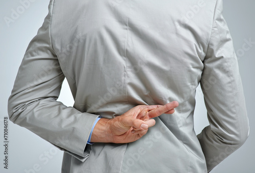 Tableau sur toile Businessman, back and fingers crossed for dishonesty in studio, scam and lying or corrupt professional