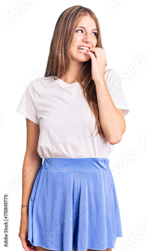 Young beautiful blonde woman wearing summer style looking stressed and nervous with hands on mouth biting nails. anxiety problem.