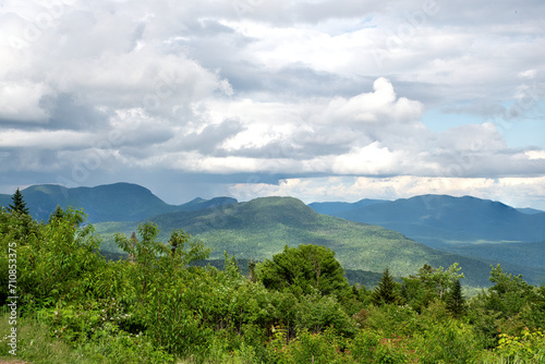 View from scenic overlook along the Kancamagus Highway in New Hampshire. Threatening storm clouds gathering over mountains in the White Mountain National Forest. photo