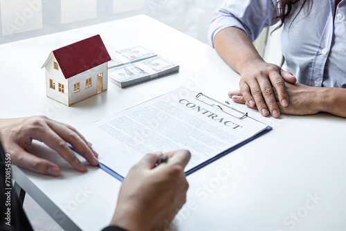 Estate agent broker reach contract form and presentation to client signing agreement contract real estate with approved mortgage application form, buying mortgage loan offer for and house insurance