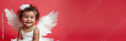 laughing baby angel cupid with white wings on red, valentines day sale and promotion, banner empty place for text photo