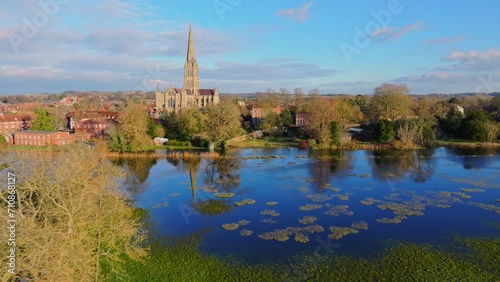 Aerial shot flying over flooded fields with reflective water and Salisbury Cathedral in background photo