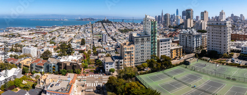 Panoramic view of aerial Lombard Street, an east west street in San Francisco, California. Famous for steep, one block section with eight hairpin turns. Tennis courts in San Francisco. photo