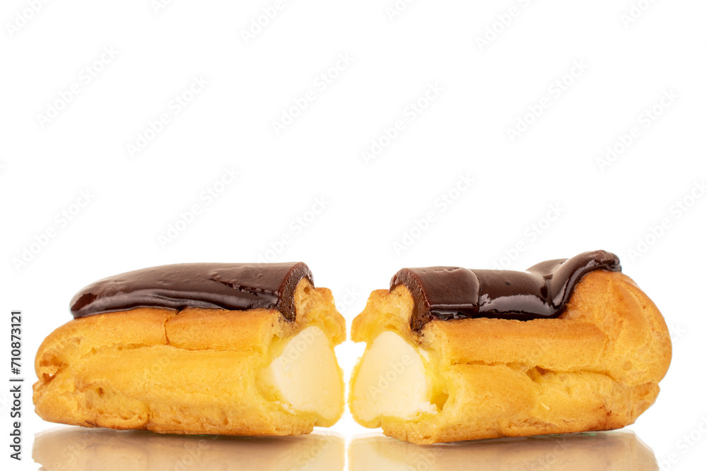 Two halves of a delicious chocolate eclair, close-up isolated on white.