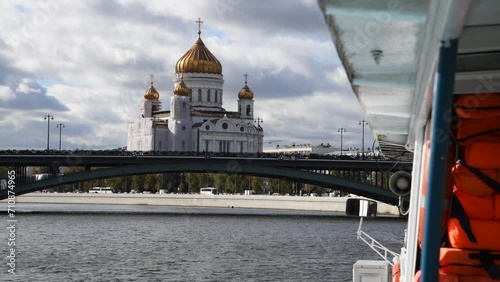 View from sailing tourboat of Russian orthodox Cathedral of Christ the Saviour in a cloudy autumn day in Moscow, Russia. Soft focus. Real time handheld video. Travel in Russia theme.