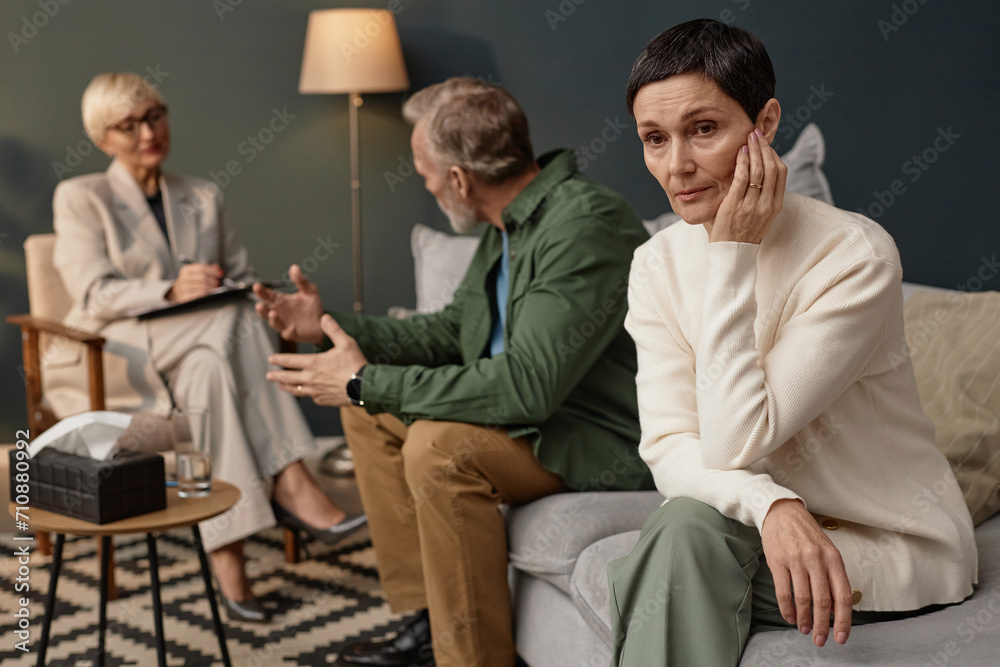 Obraz premium Portrait of distressed mature woman looking away during couples therapy session or counselling