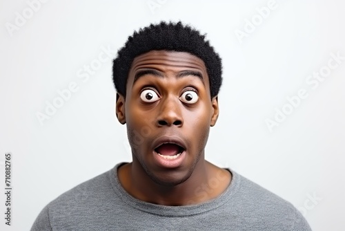 Portrait of young african american excited man on white background