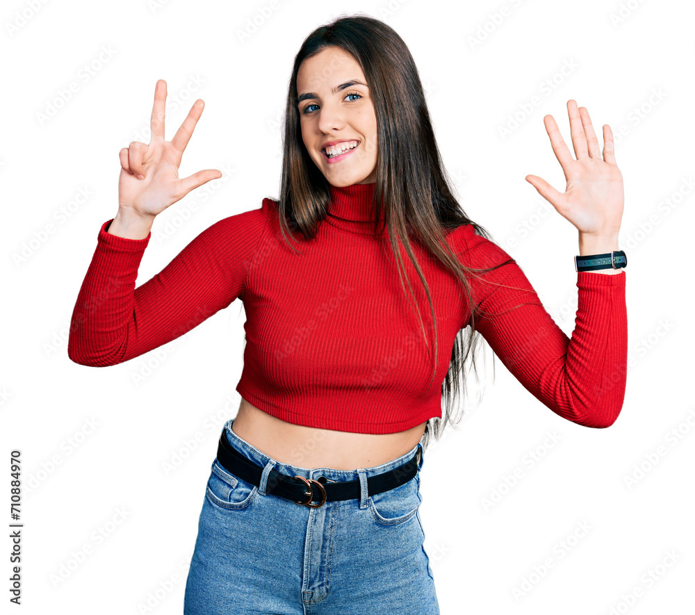 Young brunette teenager wearing red turtleneck sweater showing and pointing up with fingers number eight while smiling confident and happy.