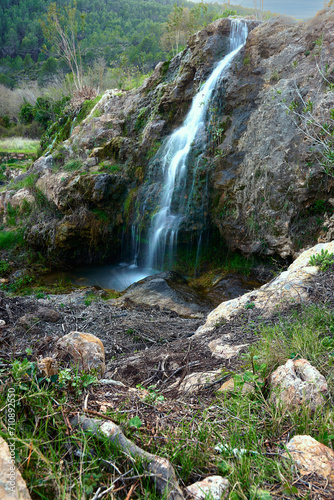 Small waterfalls in a mountain stream on a sunny day