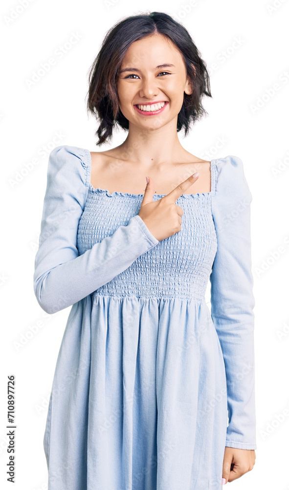 Young beautiful girl wearing casual clothes cheerful with a smile on face pointing with hand and finger up to the side with happy and natural expression Young beautiful girl wearing casual clothes cheerful with a smile on face pointing with hand and finger up to the side with happy and natural expression