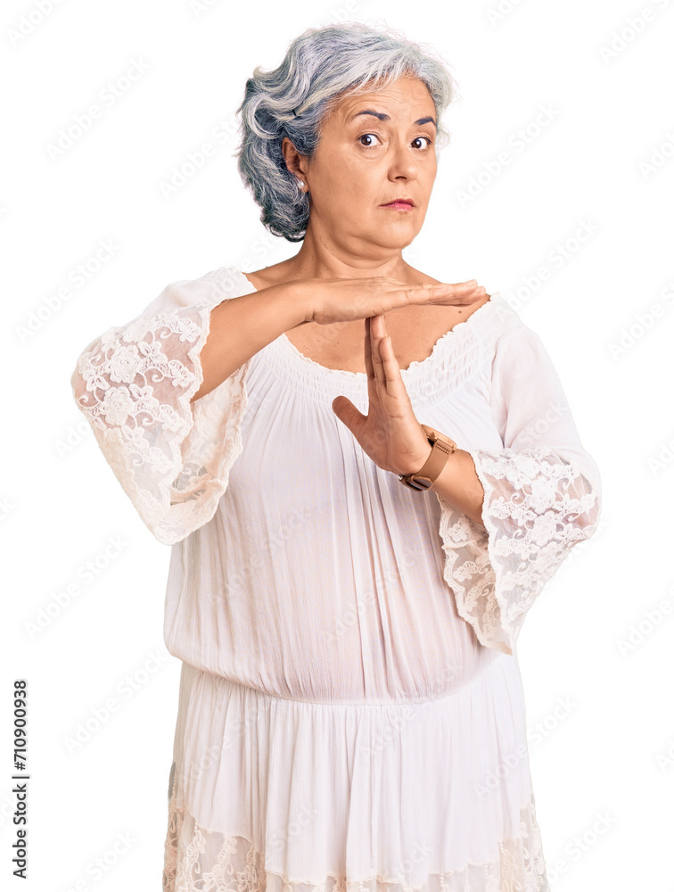 Senior woman with gray hair wearing bohemian style doing time out gesture with hands, frustrated and serious face Senior woman with gray hair wearing bohemian style doing time out gesture with hands, frustrated and serious face