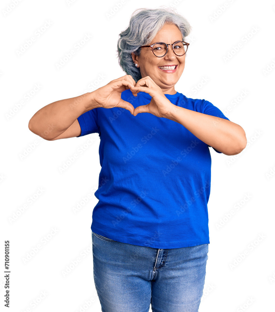 Senior woman with gray hair wearing casual clothes and glasses smiling in love showing heart symbol and shape with hands. romantic concept. Senior woman with gray hair wearing casual clothes and glasses smiling in love showing heart symbol and shape with hands. romantic concept.