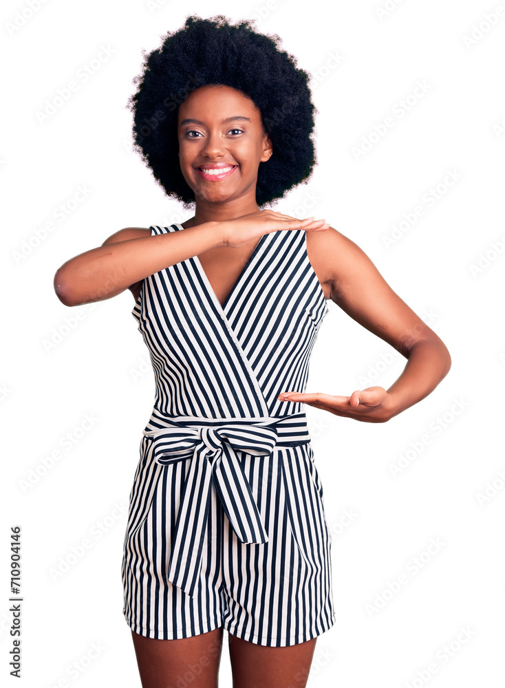 Young african american woman wearing casual clothes gesturing with hands showing big and large size sign, measure symbol. smiling looking at the camera. measuring concept. Young african american woman wearing casual clothes gesturing with hands showing big and large size sign, measure symbol. smiling looking at the camera. measuring concept.