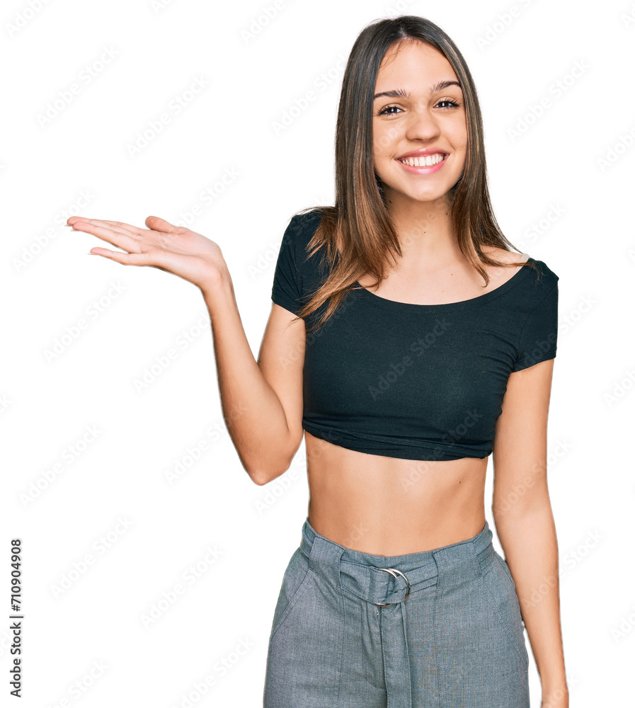 Young brunette woman wearing casual clothes smiling cheerful presenting and pointing with palm of hand looking at the camera. Young brunette woman wearing casual clothes smiling cheerful presenting and pointing with palm of hand looking at the camera.