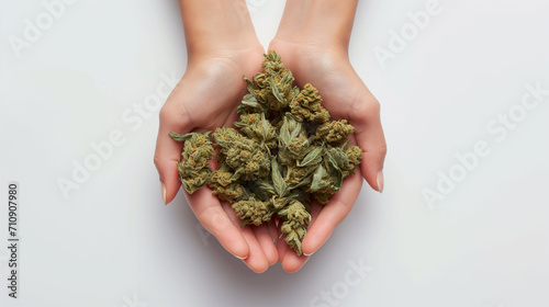 Close up of hands holding a cannabis nug isolated over white background photo