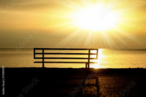 A Sunset by the sea bench in nature travel silhouette