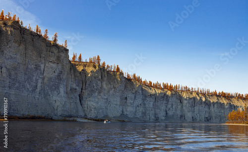 Rocky steep banks of the northern Siberian river on clear autumn day.
