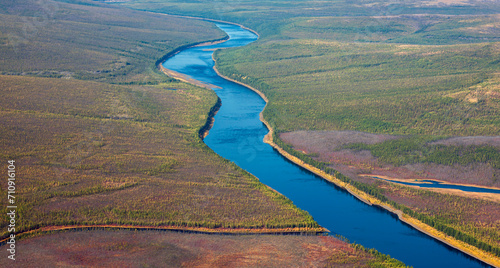 Helicopter view of the autumn Siberian taiga and the Tunguska River with its tributary. photo