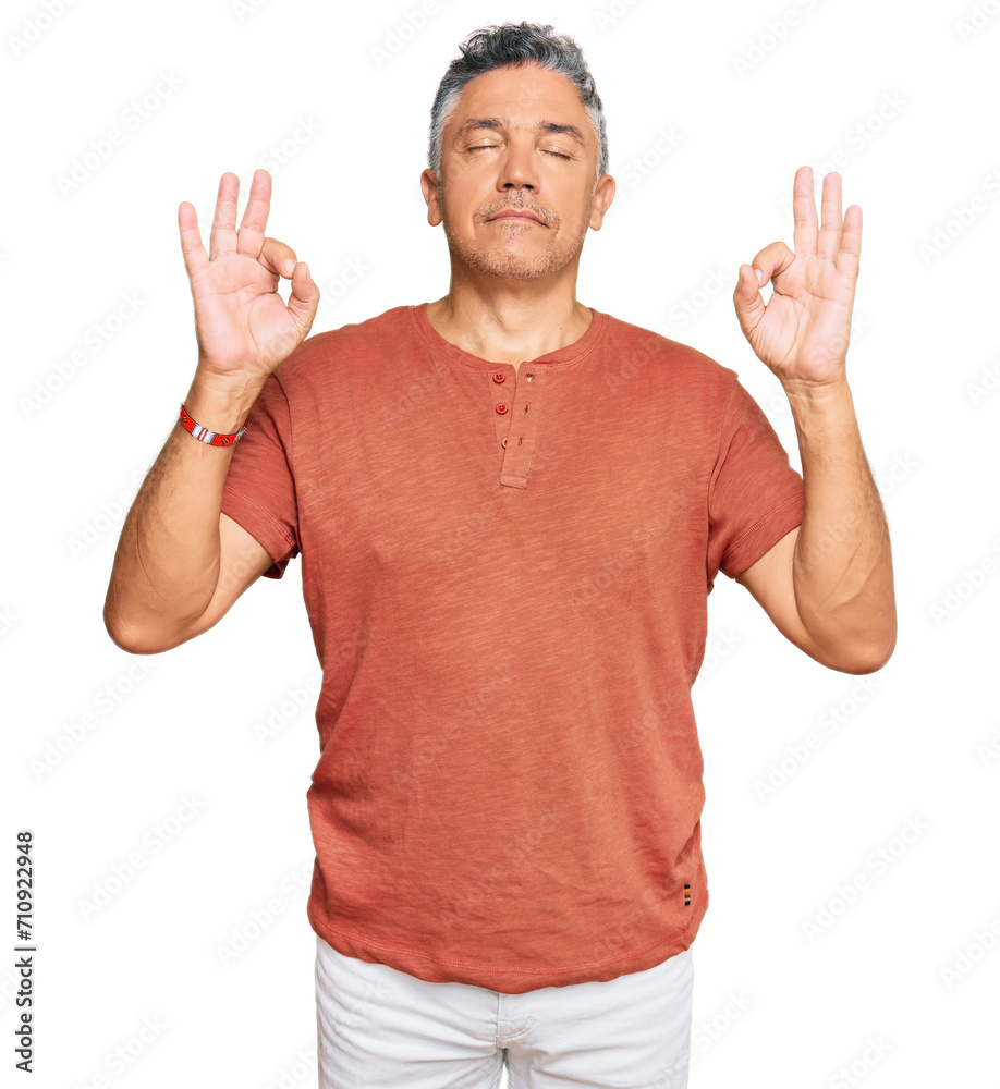Handsome middle age man wearing casual clothes relax and smiling with eyes closed doing meditation gesture with fingers. yoga concept. Handsome middle age man wearing casual clothes relax and smiling with eyes closed doing meditation gesture with fingers. yoga concept.