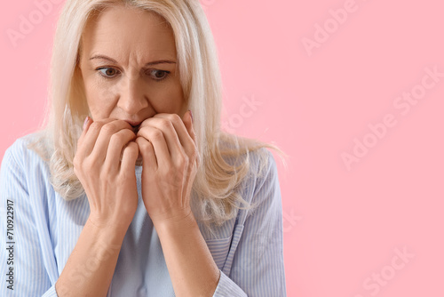 Mature woman on pink background, closeup