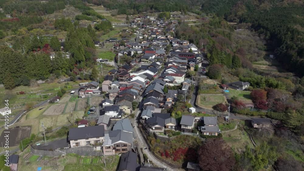 Aerial tilt up shot of Magome, aka Magome-juku, during autumn season in Japan. Magome is a former post town on the Nakasendo trail, a major route that connected Tokyo with Kyoto in the feudal ages.