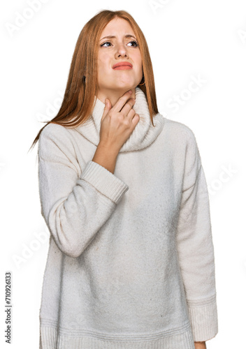 Young irish woman wearing casual winter sweater touching painful neck, sore throat for flu, clod and infection photo