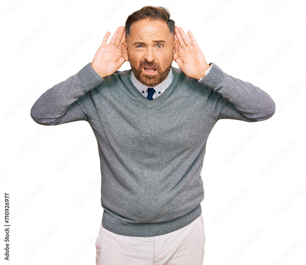 Handsome middle age man wearing business clothes trying to hear both hands on ear gesture, curious for gossip. hearing problem, deaf Handsome middle age man wearing business clothes trying to hear both hands on ear gesture, curious for gossip. hearing problem, deaf