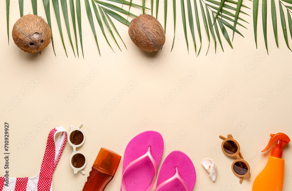 Composition with palm leaves, coconuts and different beach accessories on beige background Composition with palm leaves, coconuts and different beach accessories on beige background