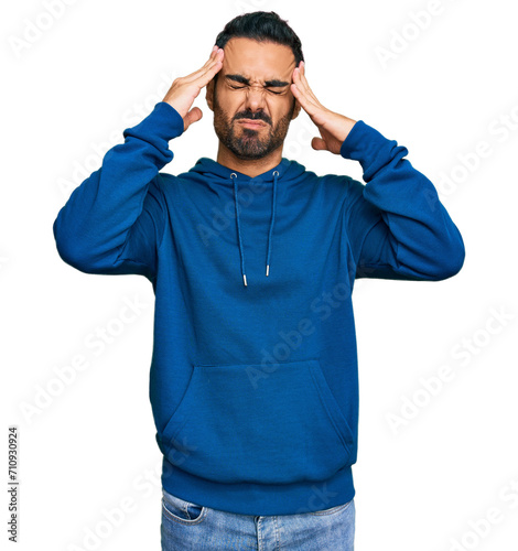 Young hispanic man wearing casual clothes suffering from headache desperate and stressed because pain and migraine. hands on head.