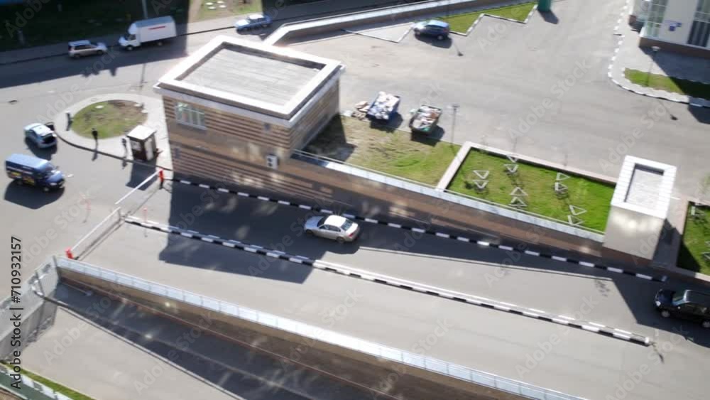 Two cars drive out of courtyard by marked paths, top view. Two cars drive out of courtyard by marked paths, top view.