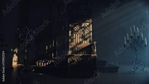 Tableau sur toile Large carved wooden throne in a dark church room