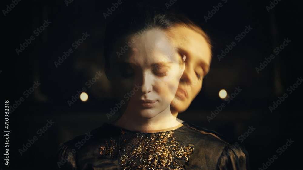 Close-up portrait of a woman with closed eyes on a dark background - obrazy, fototapety, plakaty 