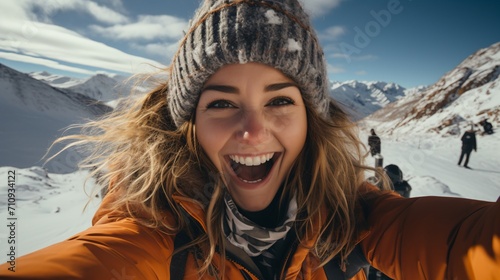 Ecstatic young woman on a snowy mountaintop
