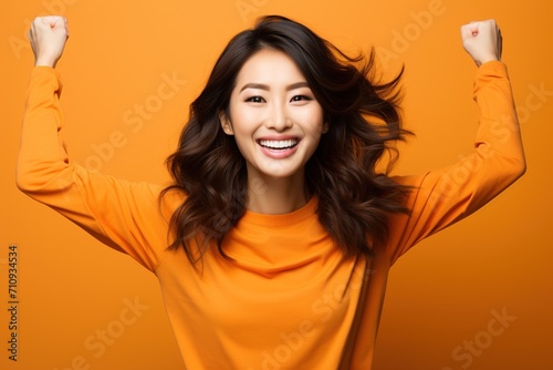 Ecstatic Asian woman celebrating her success