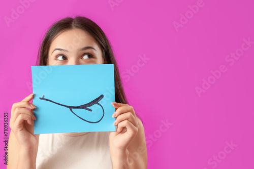 Young Asian woman with pape...