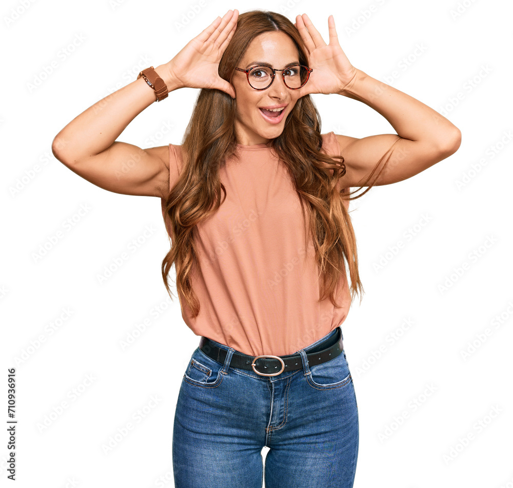 Young hispanic woman wearing casual clothes and glasses smiling cheerful playing peek a boo with hands showing face. surprised and exited Young hispanic woman wearing casual clothes and glasses smiling cheerful playing peek a boo with hands showing face. surprised and exited