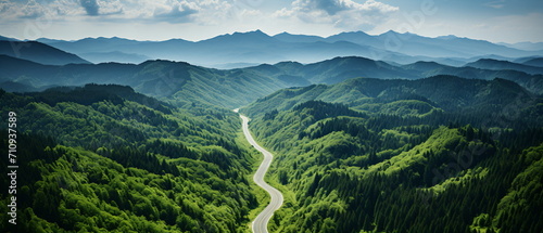 Scenic view of a winding road through a lush green mountain valley