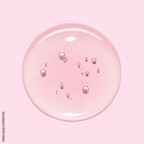 Serum oil sample swatch round shape texture isolated on pinkbackground. cosmetic Hyaluronic acid retinol collagen science lab product