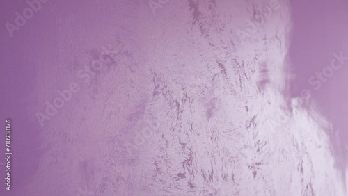Light pink painted plaster textured wall in a room. photo