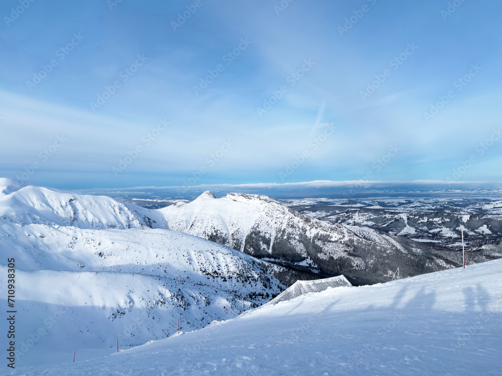 Top of mountain, snowy peaks of Tatras mountain, beautiful landscape, winter tourism. Kasprowy Wierch in day with good weather, blue sky