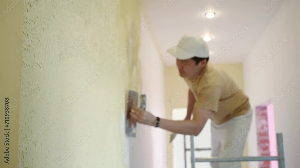 Two builders making finish in the apartment with yellow walls. Two builders making finish in the apartment with yellow walls.