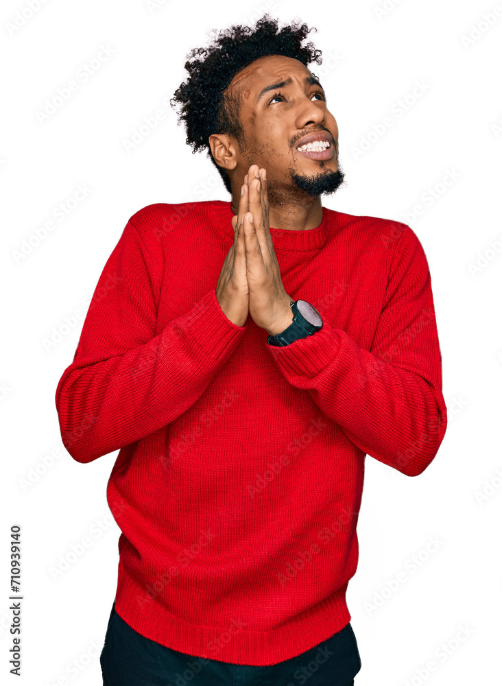 Young african american man with beard wearing casual winter sweater begging and praying with hands together with hope expression on face very emotional and worried. begging. Young african american man with beard wearing casual winter sweater begging and praying with hands together with hope expression on face very emotional and worried. begging.