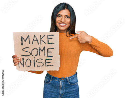 Young latin transsexual transgender woman holding make some noise banner pointing finger to one self smiling happy and proud
