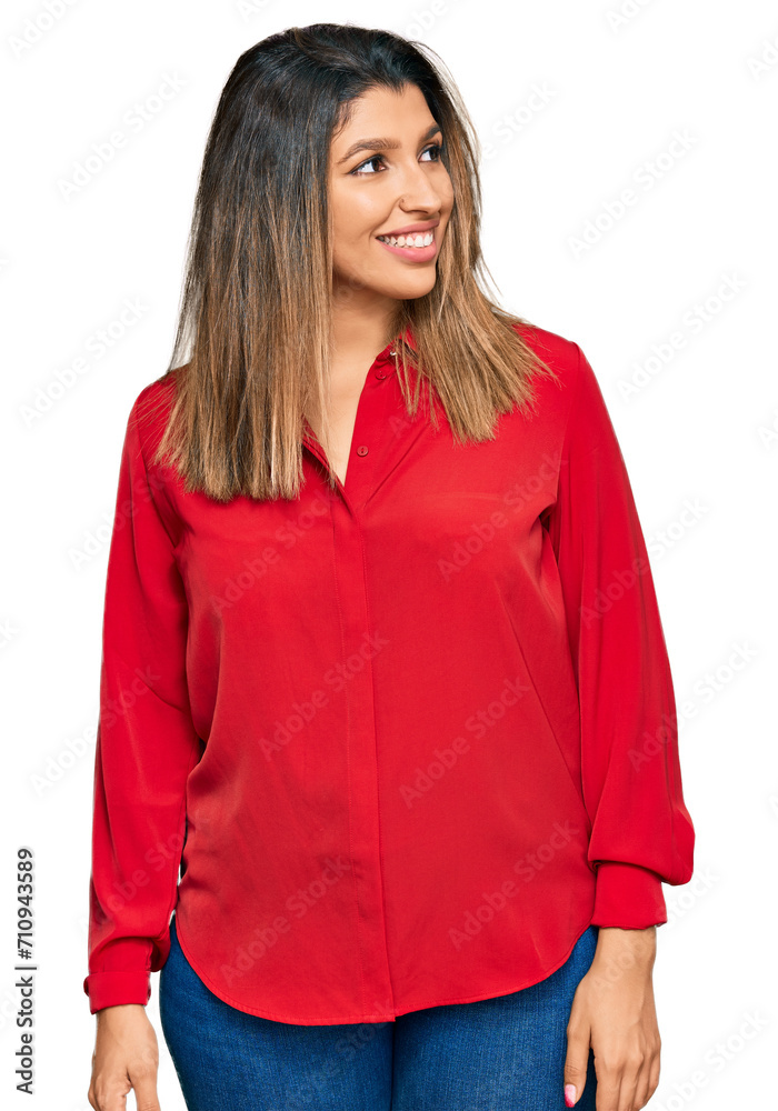 Beautiful brunette woman wearing casual clothes looking away to side with smile on face, natural expression. laughing confident.