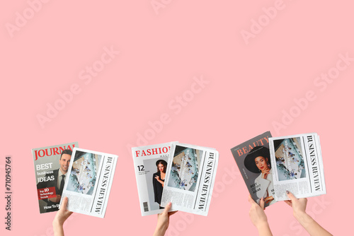 Women with newspapers and magazines on pink background photo