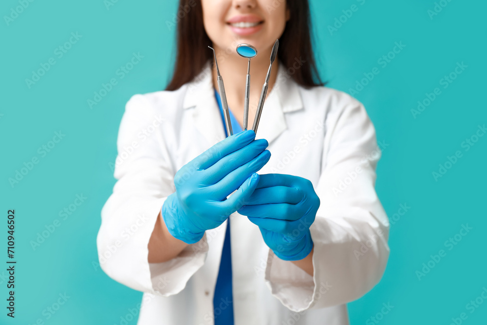 Female dentist with tools on blue background. World Dentist Day Female dentist with tools on blue background. World Dentist Day