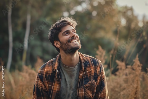 Happy man standing on road in front of trees