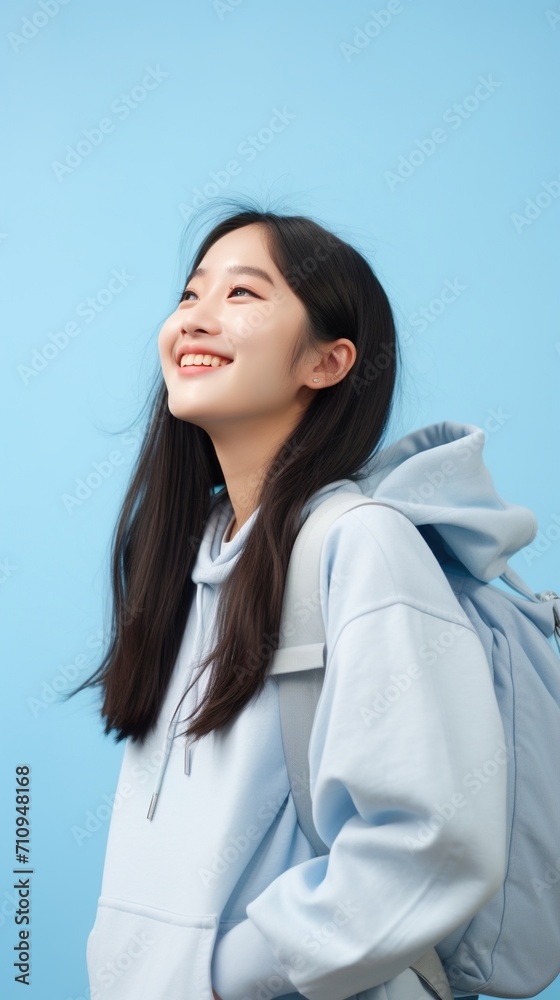 Smiling Asian young woman wearing a hoodie Smiling Asian young woman wearing a hoodie