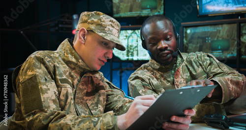 Fotografie Two mixed-races army officers talking about secret operation
